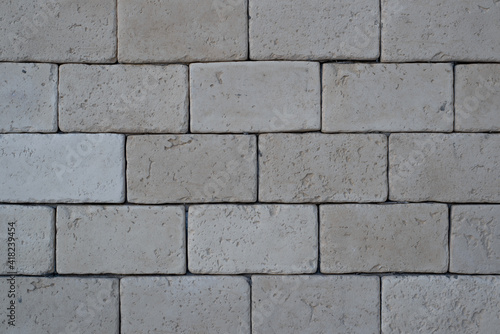 Brickwork from gray, large bricks close-up, outside.