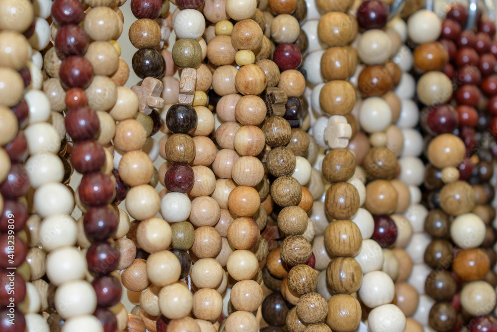 Wooden beads. Round beads of various colors and textures. Selective focus. Wooden beads. Round beads of various colors and textures. Selective focus.