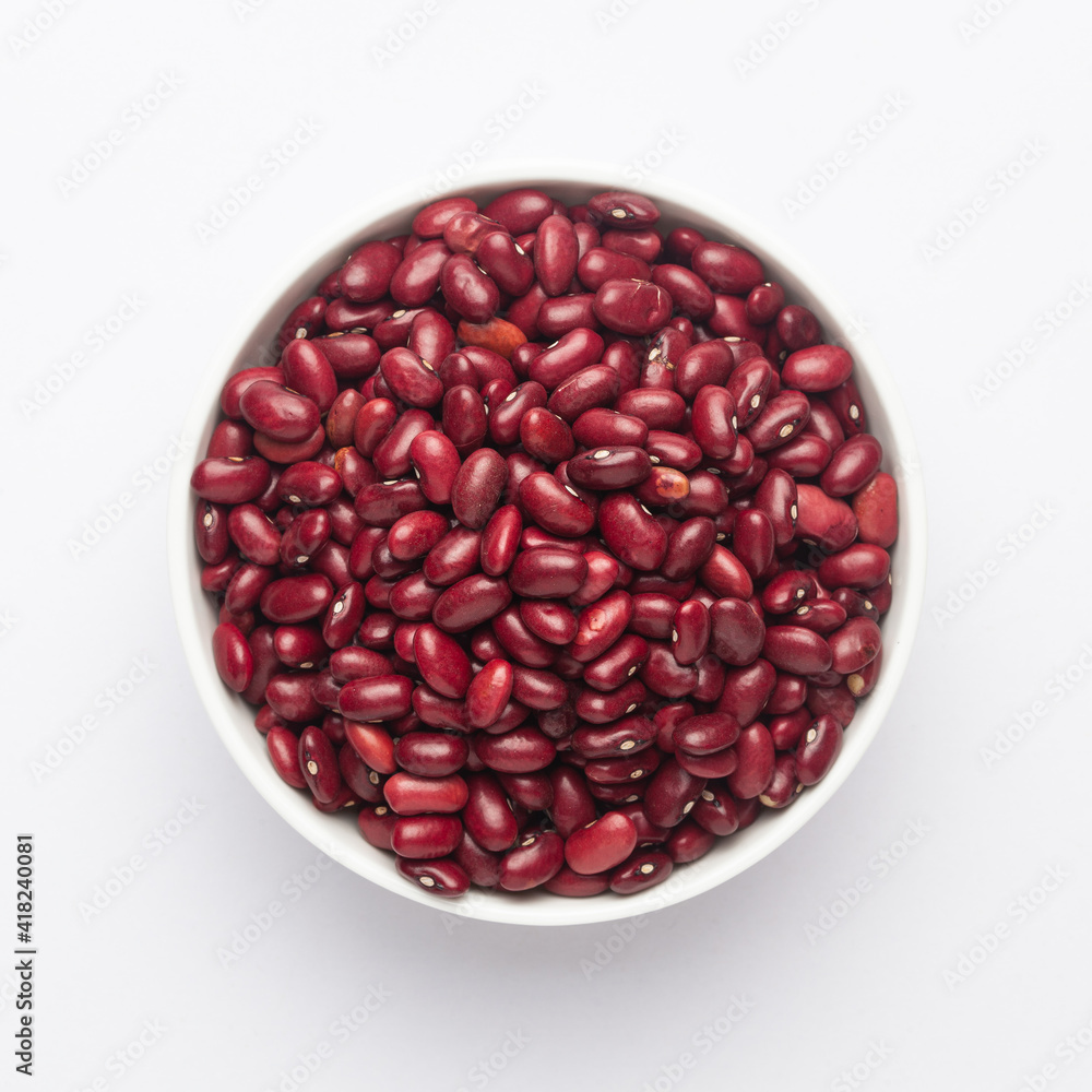 Close up of Organic Rajma, (Laal Lobia ) or red kidney beans dal on a ceramic white bowl. Top view Close up of Organic Rajma, (Laal Lobia ) or red kidney beans dal on a ceramic white bowl. Top view