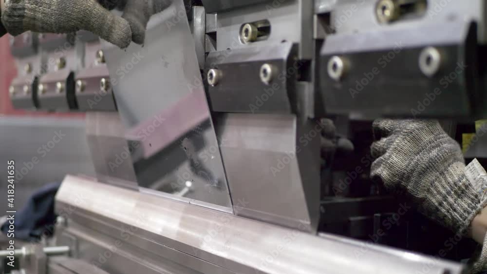 Worker operating metal press machine at Bending in factory