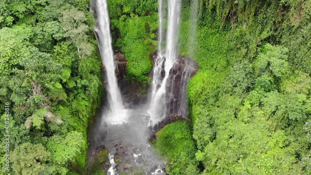 Waterfall in green rainforest. Aerial view of waterfall in the mountain jungle. Bali,Indonesia. Waterfall in green rainforest. Aerial view of waterfall in the mountain jungle. Bali,Indonesia.