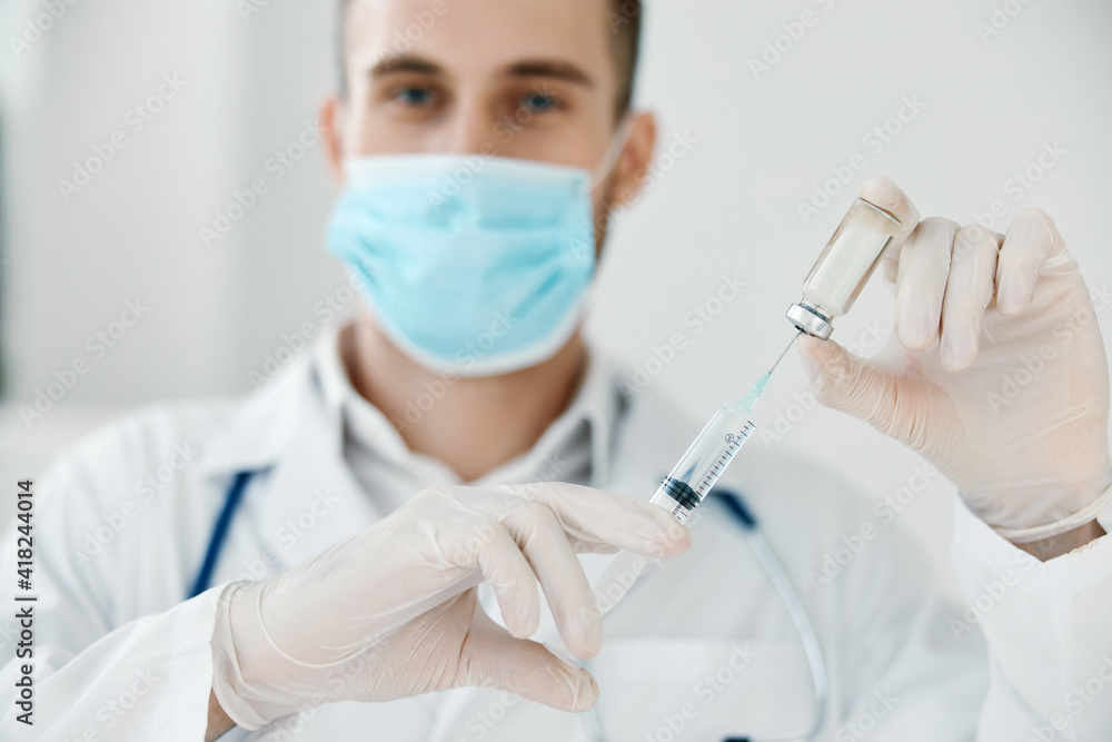 doctor with syringe in hand coronavirus vaccine medical gown face mask vaccination doctor with syringe in hand coronavirus vaccine medical gown face mask vaccination