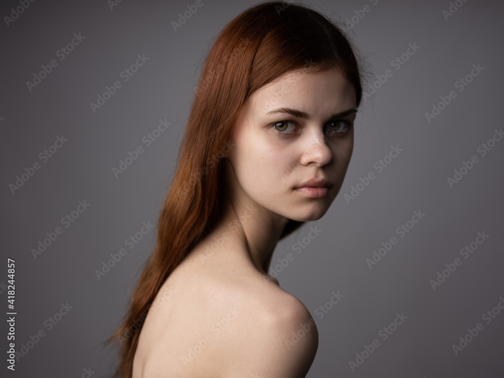 Woman portrait on gray background charming model red hair cropped look Woman portrait on gray background charming model red hair cropped look