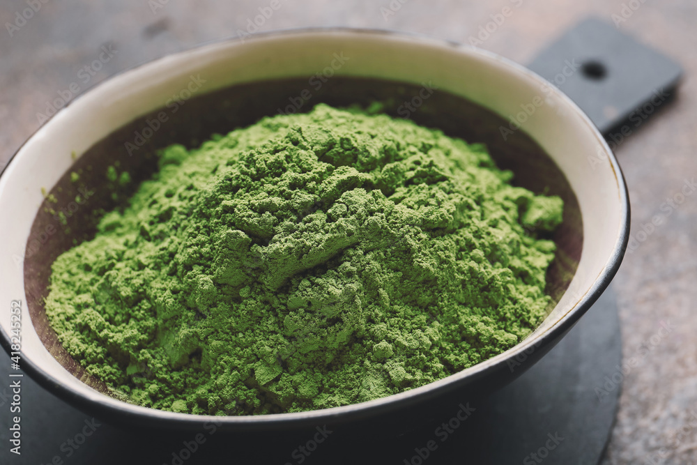 Bowl with powdered matcha tea on grunge background, closeup Bowl with powdered matcha tea on grunge background, closeup