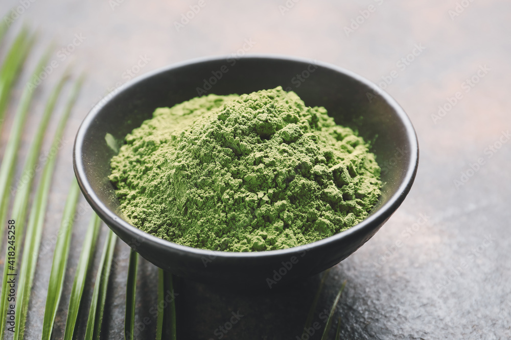 Bowl with powdered matcha tea on grunge background, closeup Bowl with powdered matcha tea on grunge background, closeup