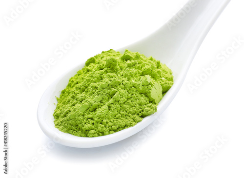Spoon with powdered matcha tea on white background