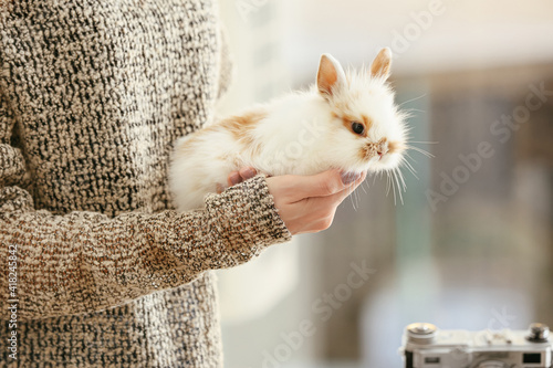 Woman with cute rabbit at home