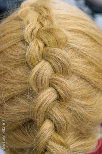 A braid. Hair braiding style - dragon. View top. Color - Pale Taupe with a golden hue.