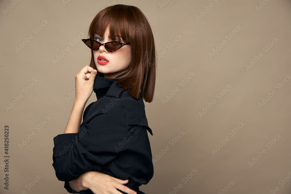 Sexy woman wrapped herself in a black coat elegant appearance beige Sexy woman wrapped herself in a black coat elegant appearance beige