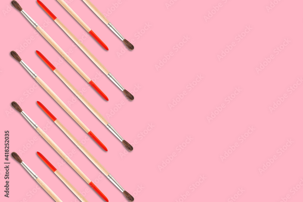 Pattern of artistic brushes for painting on a red background copy space Pattern of artistic brushes for painting on a red background copy space