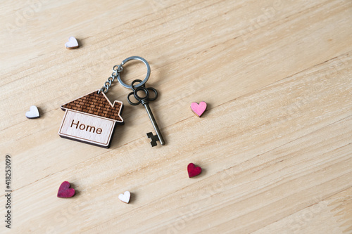 House key with home keyring on rusty wood background