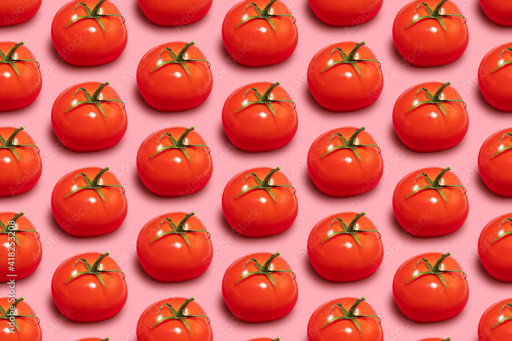 Seamless pattern of ripe tomatoes with a branch on a pink background Seamless pattern of ripe tomatoes with a branch on a pink background