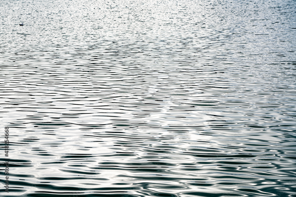 Textured background in the form of waves on the river Textured background in the form of waves on the river
