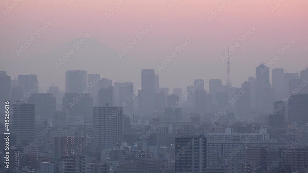 TOKYO, JAPAN : Aerial sunset CITYSCAPE of TOKYO and MOUNT FUJI. View of sun going down and buildings at downtown area. Japanese urban metropolis and nature concept. Long time lapse shot dusk to night. TOKYO, JAPAN : Aerial sunset CITYSCAPE of TOKYO and MOUNT FUJI. View of sun going down and buildings at downtown area. Japanese urban metropolis and nature concept. Long time lapse shot dusk to night.