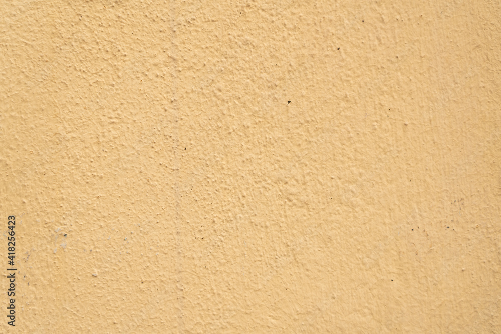 Textured background in yellow putty on the wall Textured background in yellow putty on the wall