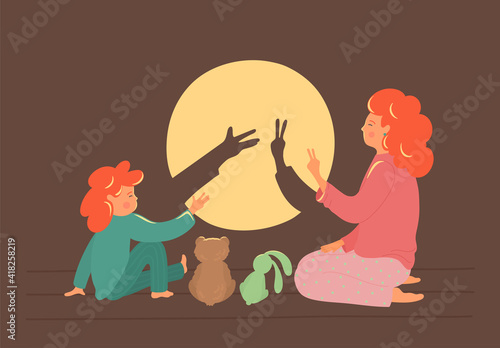 Bedtime story. Cute shadow theatre. Mother with child play in the shadows theatre. Children development concept.