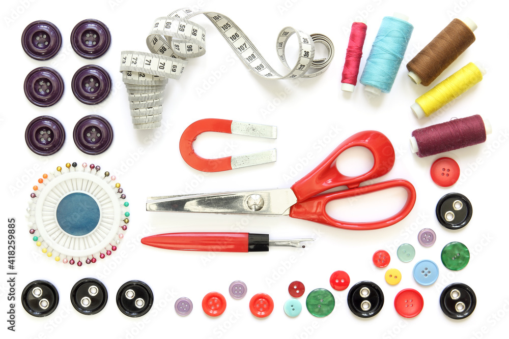 Kit design of sewing tools isolated on white background: spools of thread, needle, a pair of button scissors and a tape measure Kit design of sewing tools isolated on white background: spools of thread, needle, a pair of button scissors and a tape measure