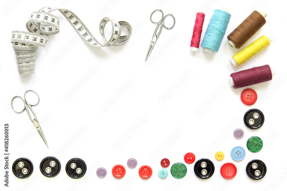 creative frame with sewing tools and accessories isolated on white background with scissors, spools of thread and tape measure creative frame with sewing tools and accessories isolated on white background with scissors, spools of thread and tape measure