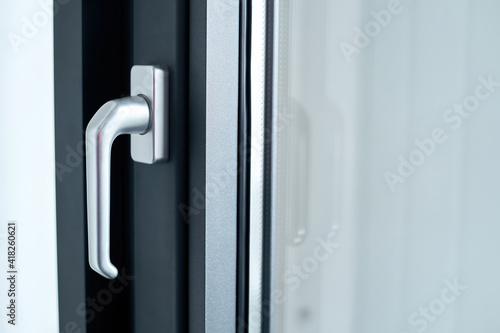 Obraz na płótnie stylish chrome handle on a dark window frame. w salonie