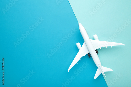 Model airplane on blue pastel color background.