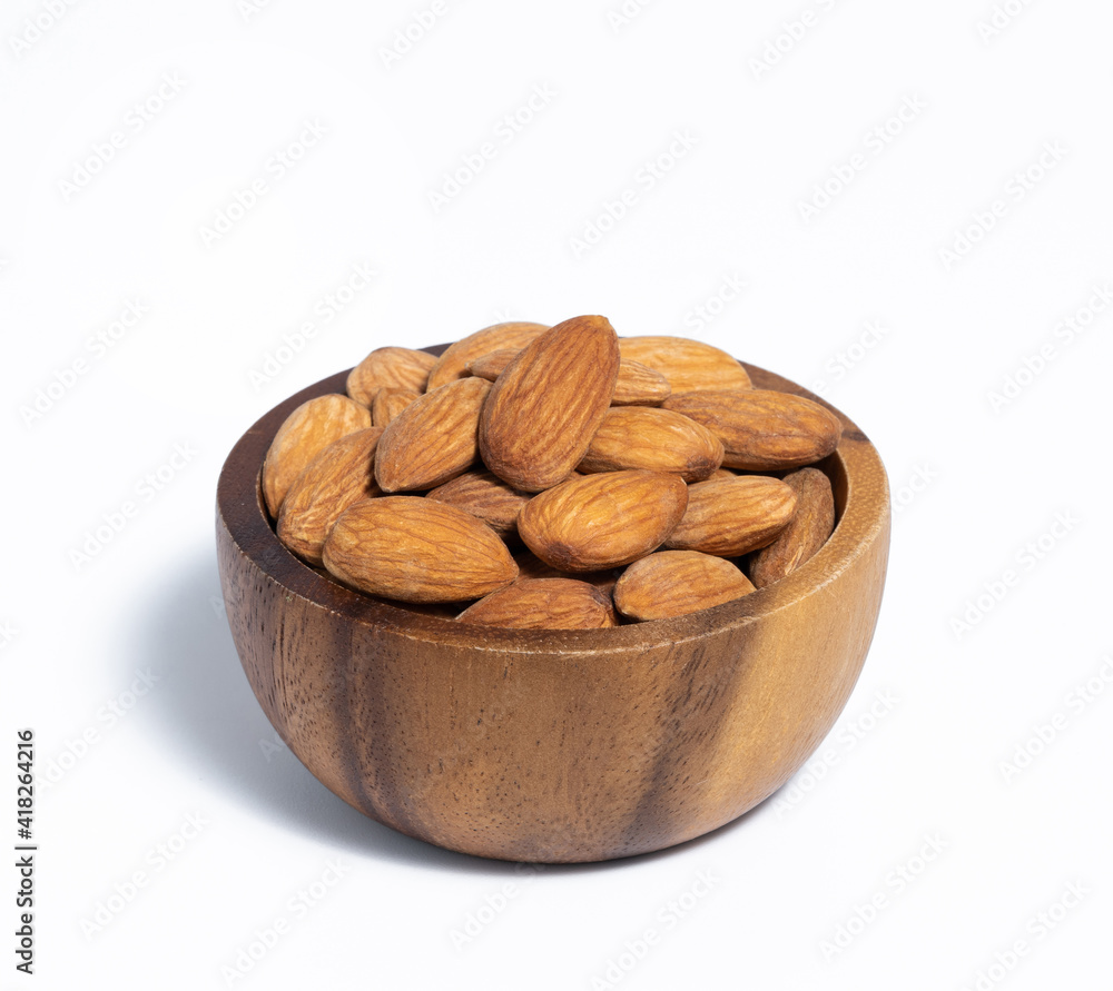 Roasted almond in wooden bowl on white background Roasted almond in wooden bowl on white background