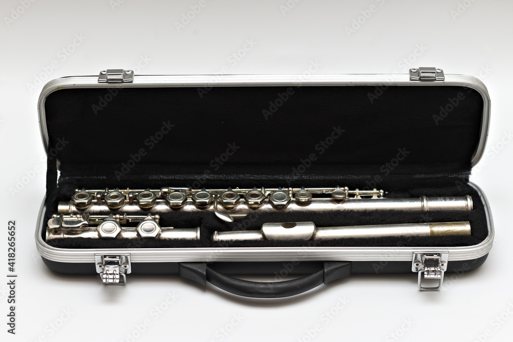 Open case with a disassembled flute lying in it Open case with a disassembled flute lying in it