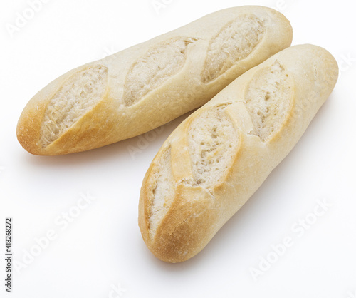 Crisp loaves of freshly made white bread. Isolated on white background.