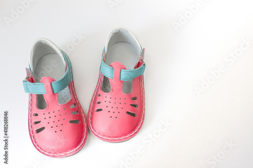 pair of baby shoes for girls on a white background