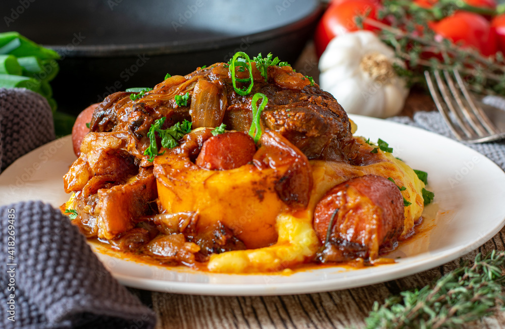 Beef stew with mashed potatoes and vegetables on a plate Beef stew with mashed potatoes and vegetables on a plate