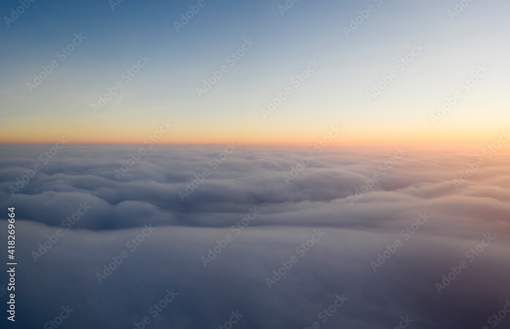 Dawn or sunset over the clouds, blue hour, aerial view.