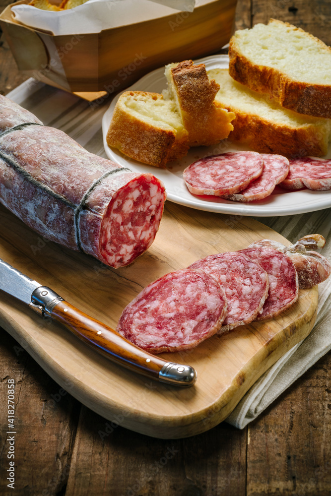 Salami sliced on wooden cutting board Salami sliced on wooden cutting board