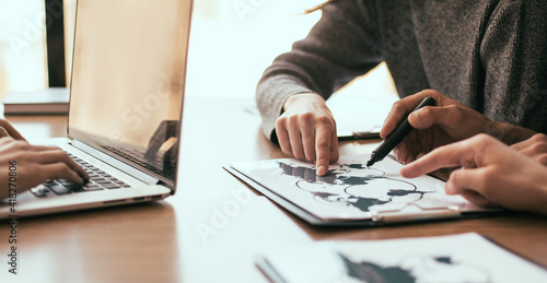 Elements of this image furnished by NASA. business colleagues discussing while sitting at the office Desk.