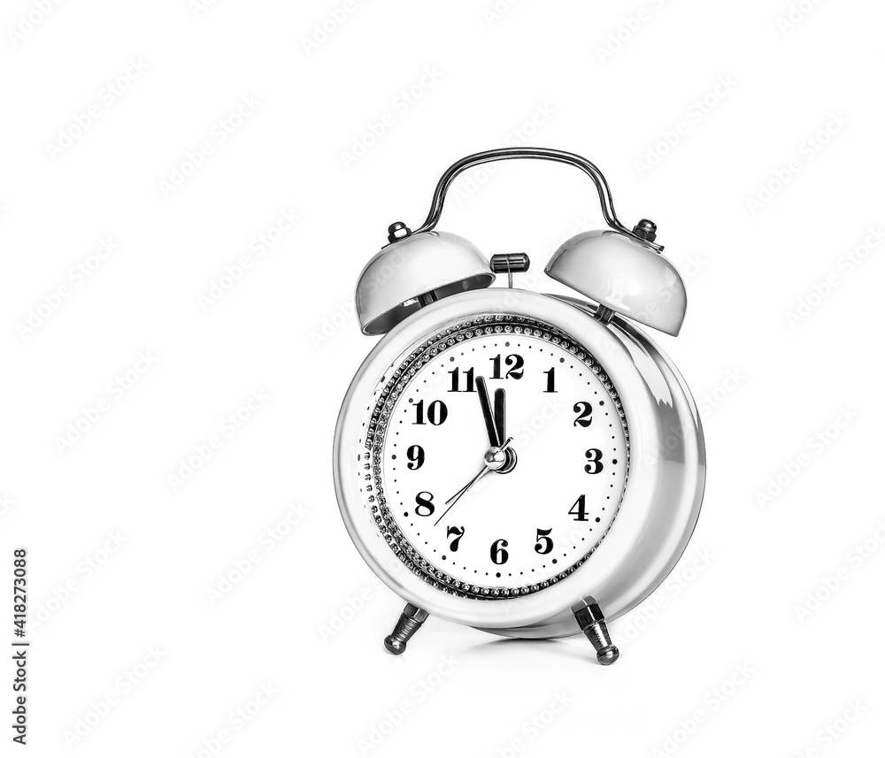 White alarm clock, hands on twelve o'clock White alarm clock, hands on twelve o'clock