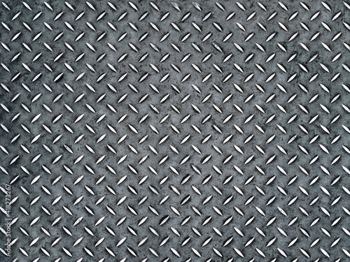 Vintage wet background of metal diamond plate in a gray silver color. Top view, copy space.