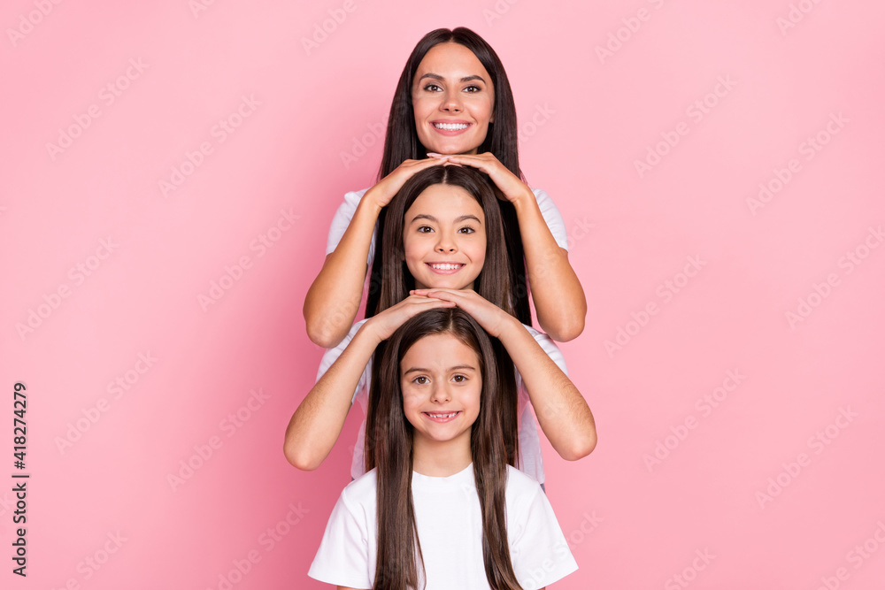 Photo portrait of small sisters smiling with mommy three generations isolated pastel pink color background Photo portrait of small sisters smiling with mommy three generations isolated pastel pink color background