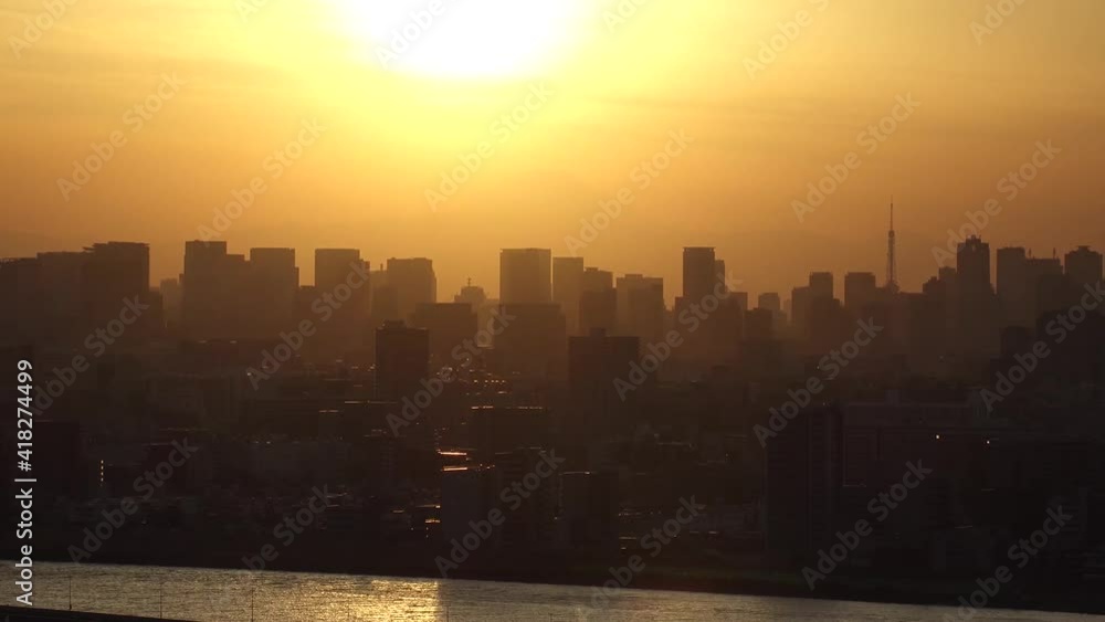 TOKYO, JAPAN : Aerial sunset CITYSCAPE of TOKYO and MOUNT FUJI. View of sun, river and buildings at downtown area. Japanese urban metropolis and nature concept. Time lapse zoom out shot dusk to night. TOKYO, JAPAN : Aerial sunset CITYSCAPE of TOKYO and MOUNT FUJI. View of sun, river and buildings at downtown area. Japanese urban metropolis and nature concept. Time lapse zoom out shot dusk to night.