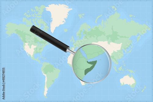 Map of the world with a magnifying glass on a map of Somalia.