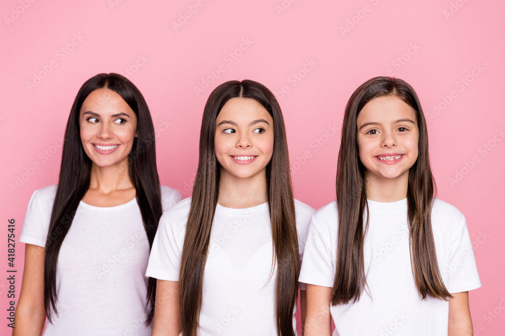 Photo portrait of smiling happy mother looking blank space and daughters wearing white t-shirts isolated pastel pink color background Photo portrait of smiling happy mother looking blank space and daughters wearing white t-shirts isolated pastel pink color background