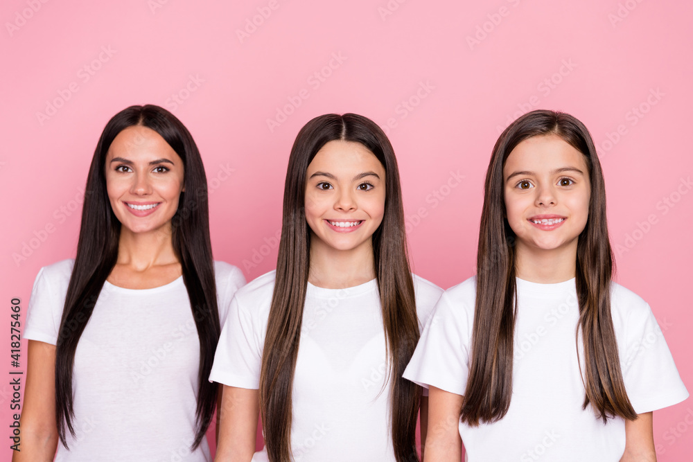Photo portrait of smiling happy mother and daughters wearing white t-shirts isolated pastel pink color background Photo portrait of smiling happy mother and daughters wearing white t-shirts isolated pastel pink color background