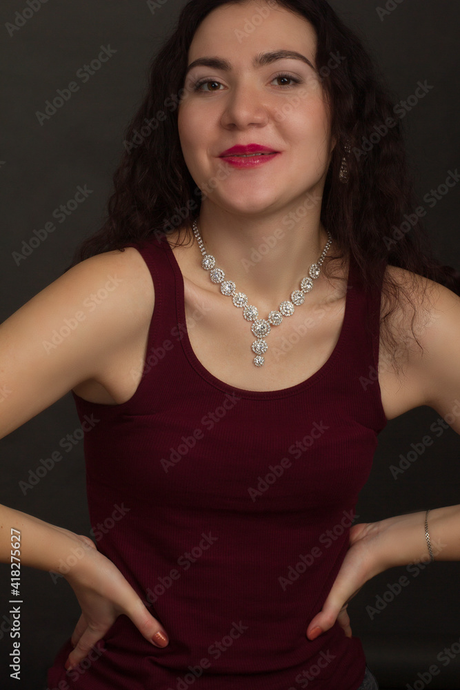Studio portrait of a brunette in burgundy T-shirt Studio portrait of a brunette in burgundy T-shirt