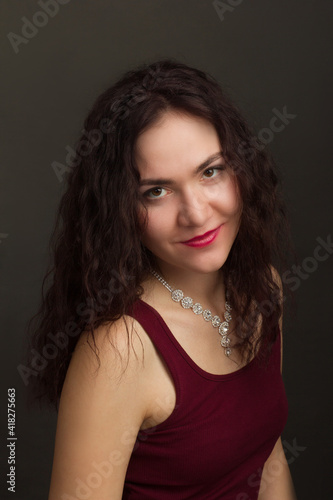 Studio portrait of a brunette in burgundy T-shirt