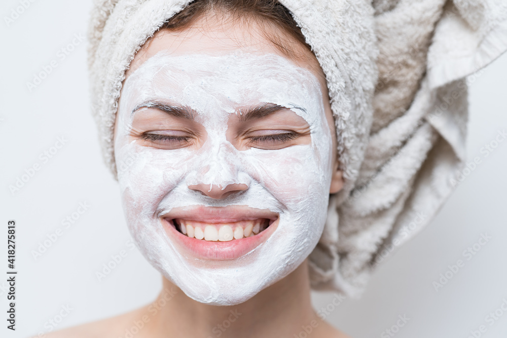woman with bare shoulders towel on head face mask skin care close-up woman with bare shoulders towel on head face mask skin care close-up