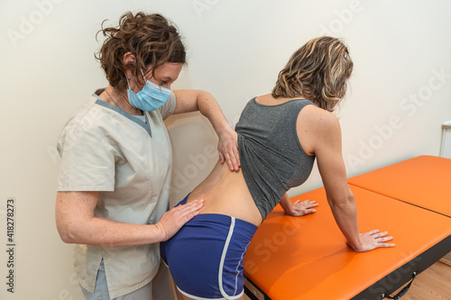Canvastavla Physiotherapist and patient in spinal posture correction session, with pandemic protection mask