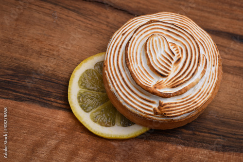Tasty lemon meringue pie on wooden table, closeup