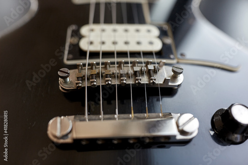 leisure, music and musical instruments concept - close up of bass guitar strings