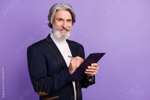 Photo of attractive cute pensioner wear black jacket writing documents clipboard isolated purple color background