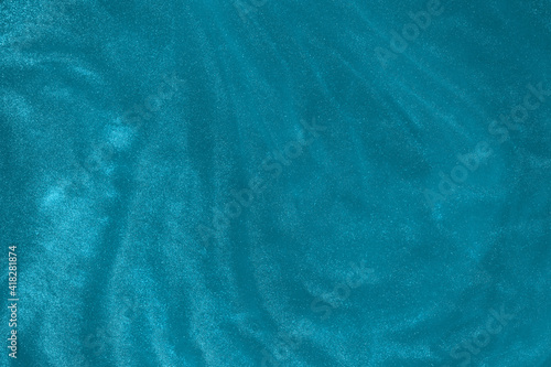 Abstract elegant, detailed mint blue glitter particles flow with shallow depth of field underwater. Holiday magic shimmering underwater space luxury background. 2021 color trend. de-focused