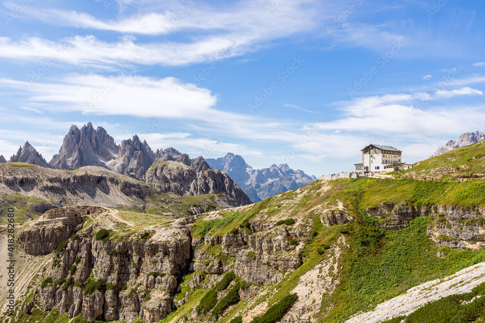 Italian Dolomites peaks and mountain hut. South Tyrol, Italy