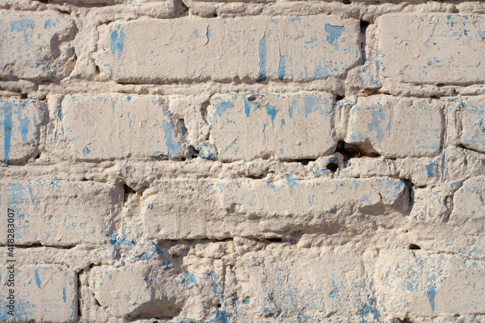 brick wall of white milky color with blue spots brick wall of white milky color with blue spots