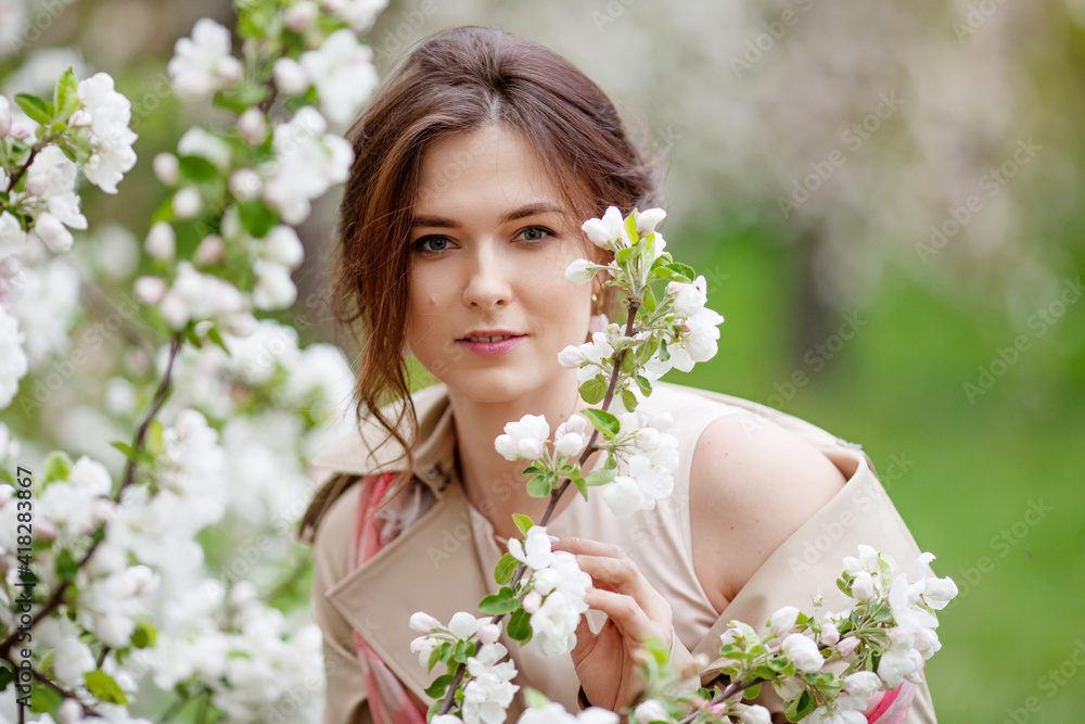 Portrait of a beautiful smiling brunette young women in blossom apple tree garden in spring time. Enjoy Nature. Healthy girl outdoor. Spring concept. Beautiful girl in orchard Portrait of a beautiful smiling brunette young women in blossom apple tree garden in spring time. Enjoy Nature. Healthy girl outdoor. Spring concept. Beautiful girl in orchard